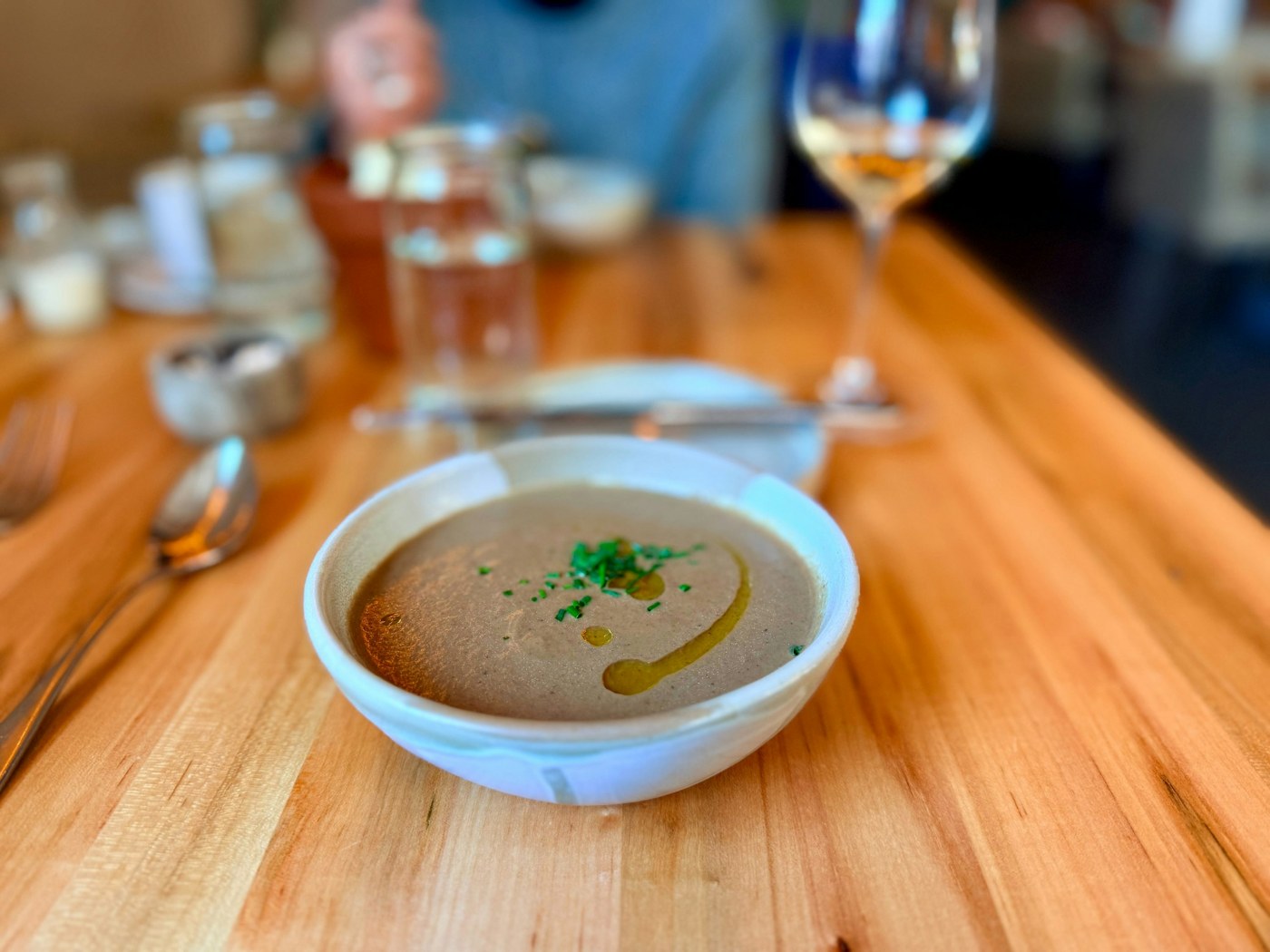 A bowl of creamy mushroom soup with garnish